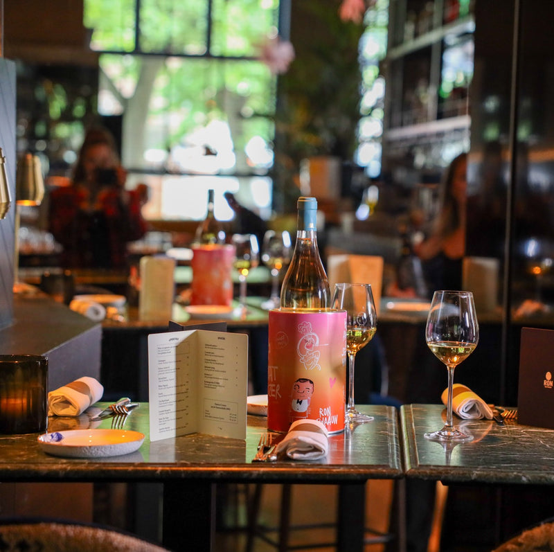 Coolenator on a restaurant dinner table with wine bottle